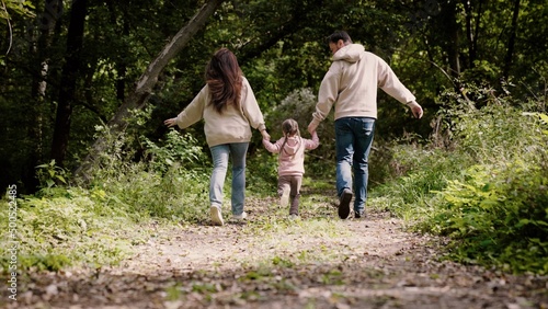 happy family children kid together run in the park at sunset silhouette. people in the park concept mom dad daughter and son joyful run. happy family and little baby child fun summer kid dream concept