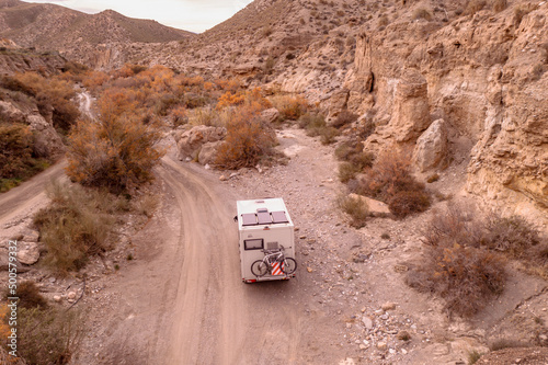 camper adventure travel in Europe Off-road Camper vehicle drives through the Rambla canyon in the Tabernas desert Spain 