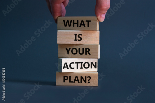 Action plan symbol. Concept words What is your action plan on wooden blocks. Businessman hand. Beautiful orange table orange background. Business What is your action plan concept. Copy space.