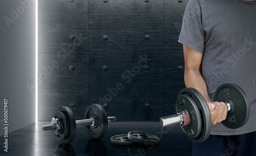 Attractive sports people are working out with dumbbells in the gym. The concept of sport and healthy lifestyle