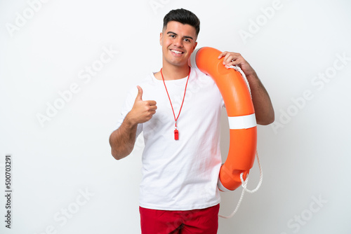 Young handsome man isolated on white background with lifeguard equipment and with thumbs up