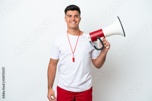Young handsome man isolated on white background with lifeguard equipment and shouting through a megaphone