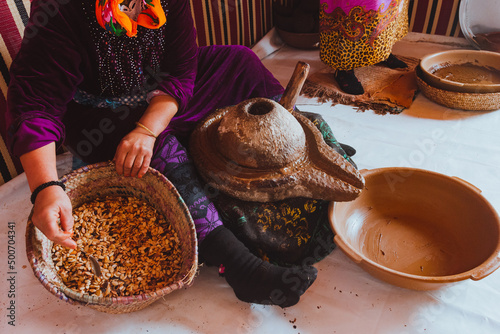 Women making argan oil, Morocco. Holding seeds with her hands. Real people doing real things. Africa
