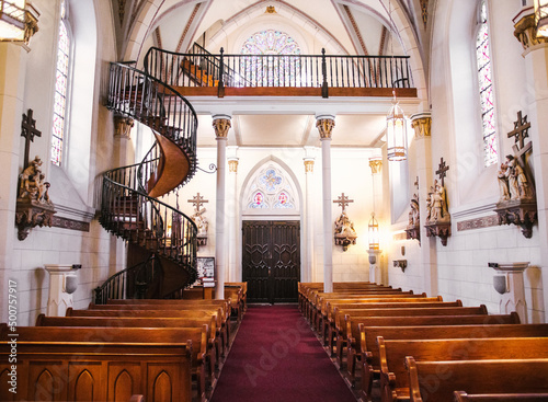 Interior of Loretto Chapel in Santa Fe, New Mexico, and the miraculous helix staircase.