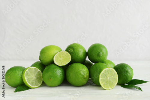 Pile of fresh limes on table