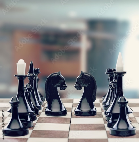 Chess pieces arranged on the chessboard in the room, board games and hobbies concept