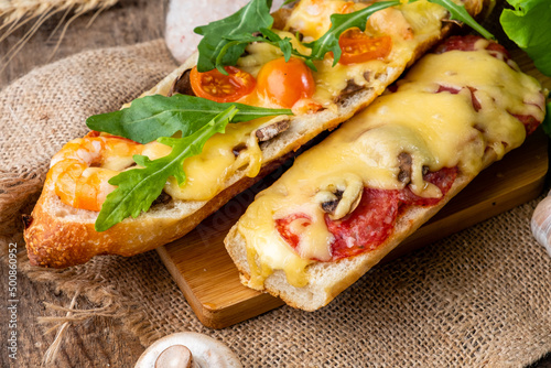 Appetizing homemade pizza cooked on a baguette, homemade pastries, pizza sandwich close-up.