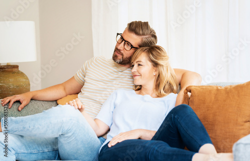 Happy couple relaxing on the couch at home