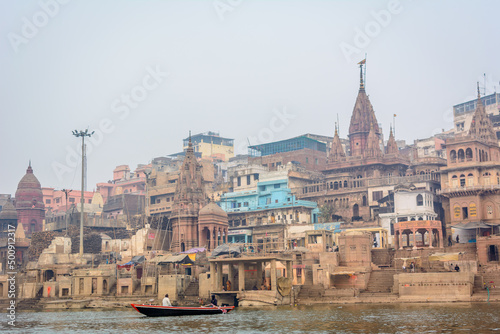 Varanasi city with ancient architecture. View of the holy Manikarnika ghat at Varanasi India at sunset.