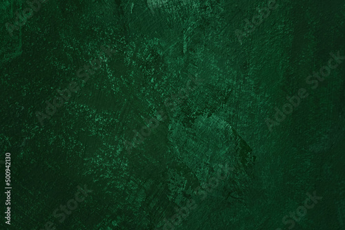 Dark green colored abstract textured background. Decorative plaster on the wall