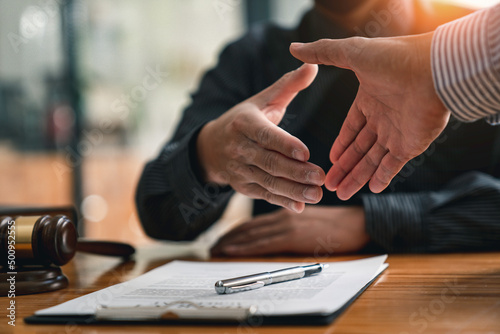 Lawyers shake hands with business people to seal a deal with partner lawyers. or a lawyer discussing contract agreements, handshake concepts, agreements, agreements