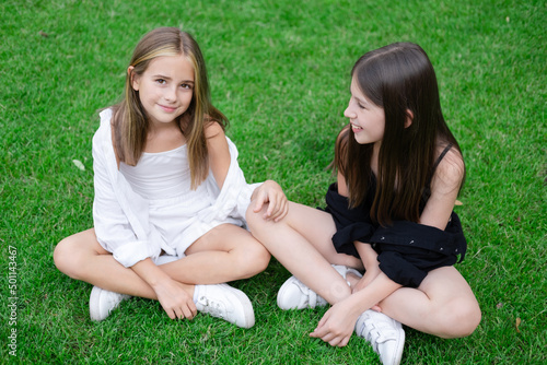 sisterhood. two sisters or friends spending time outdoors on sunny summer day. bff, sibling, girlfriend. millennial teen