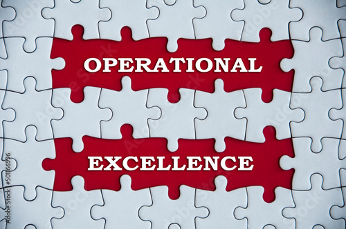 Top view of operational excellence text on missing jigsaw puzzle.
