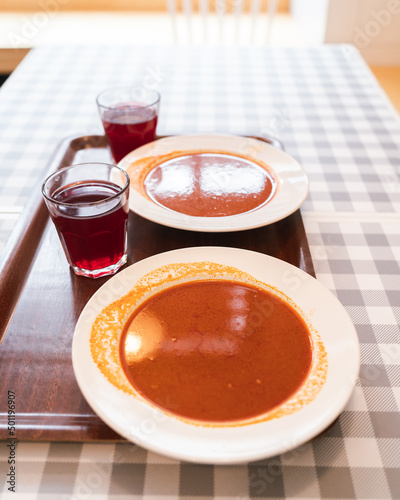Tomato soup at the polish traditional restaurant and olosih drink from fruits