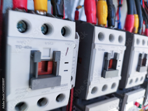 Close-up electrical wiring main contactors of machine control. 