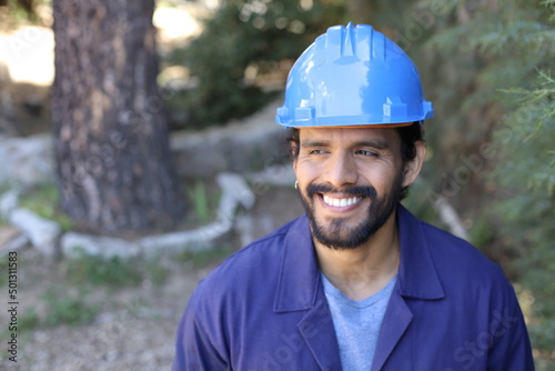 Worker wearing uniform and blue hardhat