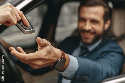 Image of man getting the keys to the automobile from the seller