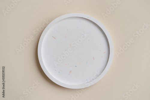 Concrete plate mock up, round dish on a beige background, concrete home decor, template for product placement, top view