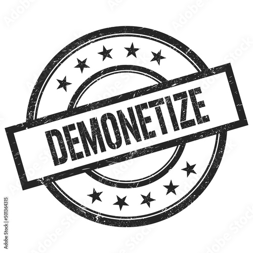 DEMONETIZE text written on black vintage round stamp.