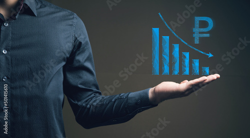 The concept of the fall of the ruble on the chart. Man holding in his hand