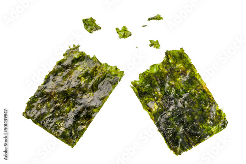 Crispy nori sheets tear off with some pieces on white background. 