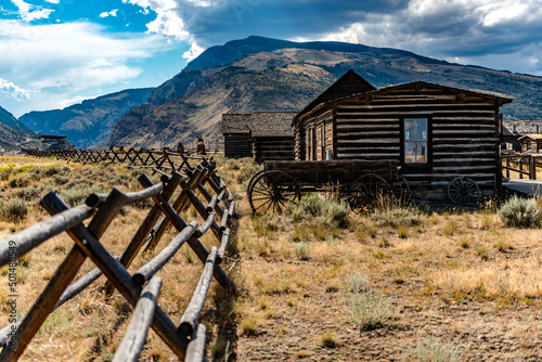 Old western house in a field with mountains in the background in Cody, Wyoming