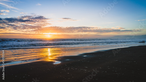 Scenic view of a beach in Christchurch, New Zealand during a beautiful sunset