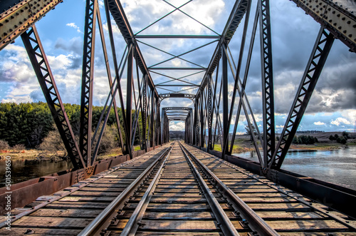 Old iron railway truss bridge built in 1893 crossing the Mississippi river in spring in Galetta, Ontario, Canada