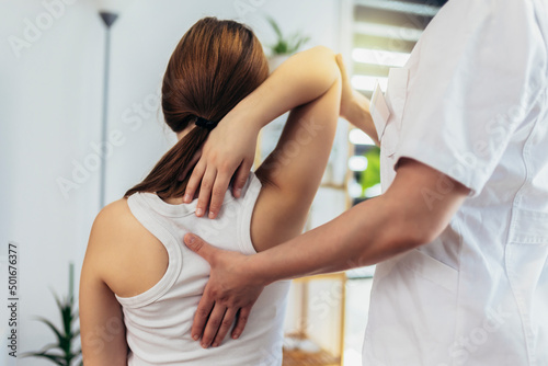 Teen Girl having chiropractic back adjustment. Osteopathy, Physiotherapy, Kinesiology. Bad posture correction