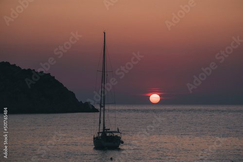 Sailing boat against sunset in Petani beach, Kefalonia, Ionian Sea