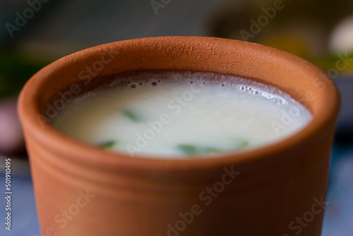 Fermented rice mixed with curd in a clay tumbler. Traditional South Indian breakfast of overnight soaked rice and plain yogurt mixed.