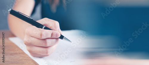 woman taking notes in papers