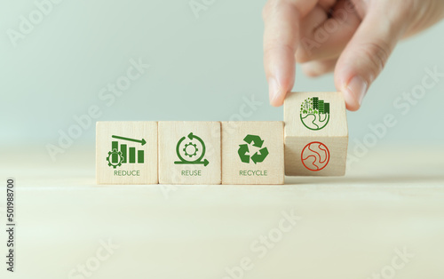 Reused, reduce and recycle concept. Limit global warming and climate change. Nurturing environmental awareness. Flipping wooden cubes from global warming to enviromental responsibility and protection.