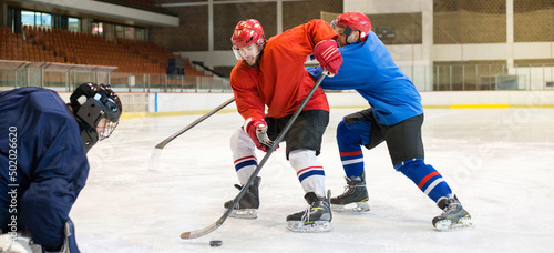 Hockey players playing hockey in the ice rink in winter 