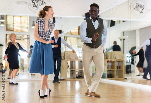 Two professional dancers practicing lindy hop in dance class