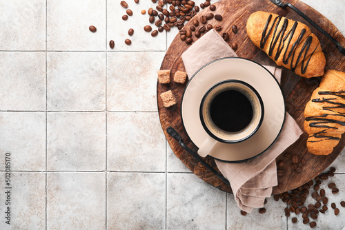 Coffee and croissant. Espresso coffee and croissant with chocolate on old cracked tile table. Perfect Croissant Breakfast in the morning. Rustic style. Top view. Mock up.
