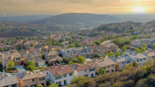 Panorama Whispy white clouds Residential area with cul-de-sac near the bottom of the slope ne