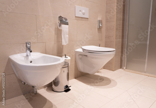 modern toilet with toilet, bidet and toiletries