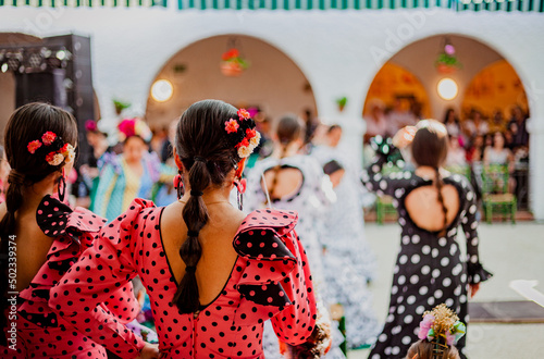 spanish woman dressed as sevillanas at a traditional festival in Rota, Spain