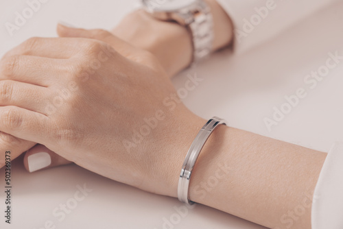 Woman wearing elegant silver bracelet