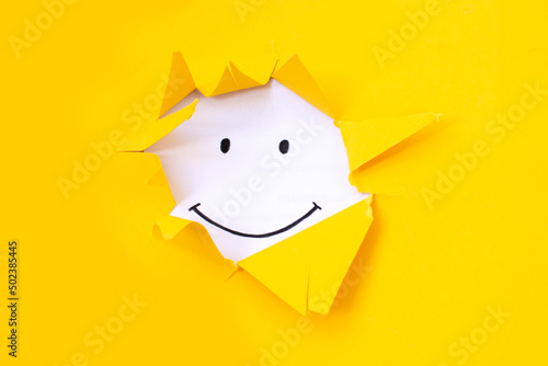 A painted smile on a yellow background. Positive thinking concept. having some bad feeling just keep smiling