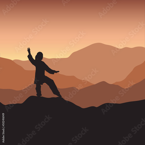 silhouette of a person in qigong pose on a mountain top
