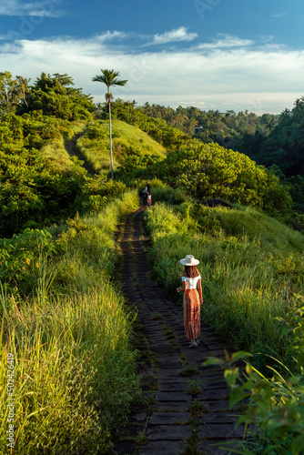Woman hiking at the Bukit Campuhan on a sunny day in Bali, Indonesia