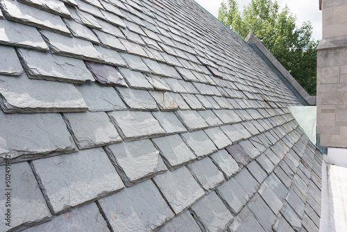 Slate roofing tiles on a historic building. Slate roofs are attractive, durable, and require specialized installation methods. 