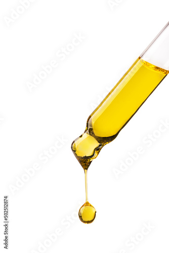 Dropper with cosmetic oil drop isolated on white background. Abstract drop of skin care oil.