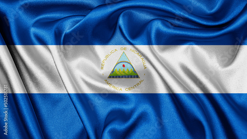 Close up realistic texture fabric textile silk satin flag of Nicaragua waving fluttering background. National symbol of the country. 15th of September, Happy Day concept 