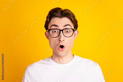 Photo of young man amazed shock omg wow impressed astonished fake information isolated over yellow color background