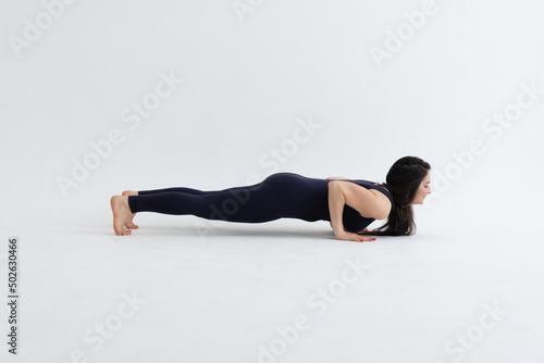 Healthy woman practicing relaxation yoga on a white background. making yoga exercises at studio. 