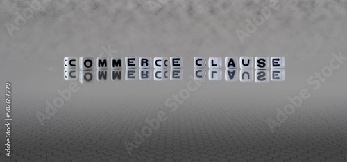 commerce clause word or concept represented by black and white letter cubes on a grey horizon background stretching to infinity