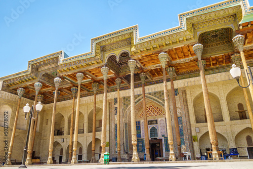 Street colonnade of the Bolo-Haouz mosque: painted wooden ceilings and carved columns. Shot in Bukhara, Uzbekistan
